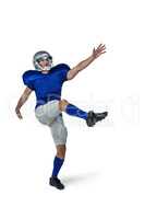 American football player kicking