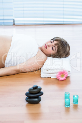 Pregnant woman lying on hardwood floor