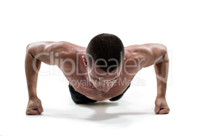 Fit shirtless athlete doing push ups