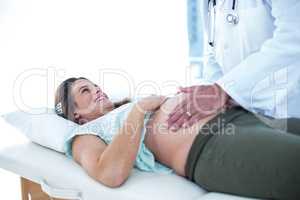 Pregnant woman examined by doctor in clinic