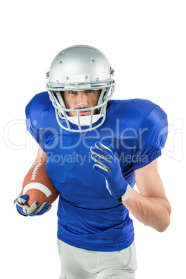 Portrait of American football player running with ball