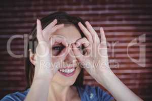 Woman holding hands as binoculars