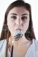 Woman lighting many cigarettes in mouth