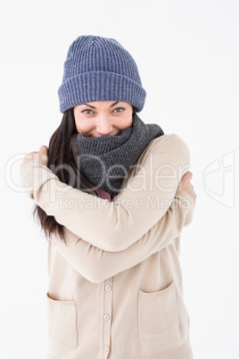 Attractive brunette looking at camera wearing warm clothes