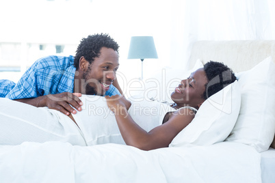 Smiling husband looking at his wife while relaxing