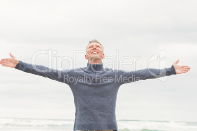 Man standing with arms out wide