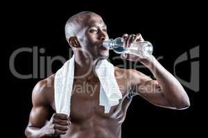 Athlete with towel around neck drinking water