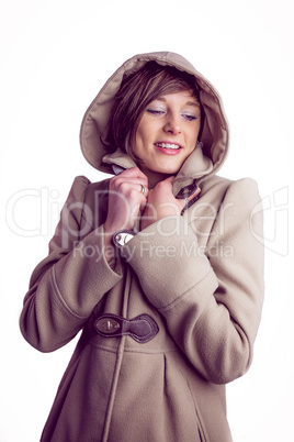 Attractive woman wearing a warm coat with hood raised