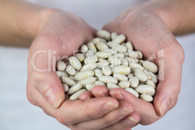 Woman showing handful of lima beans