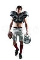 Shirtless American football player with padding holding ball and