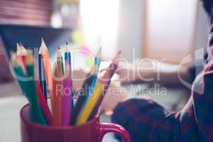 Close-up of colored pencils in mug