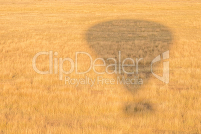 Balloon shadow making exclamation mark on ground