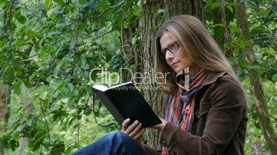 a woman sitting on a fallen tree