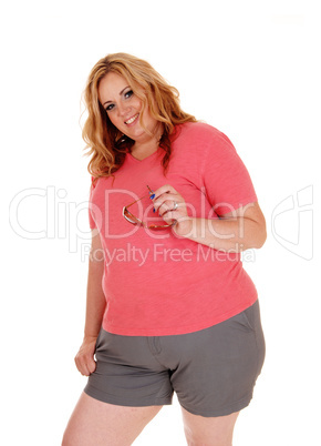 Young plus size woman standing in shorts.