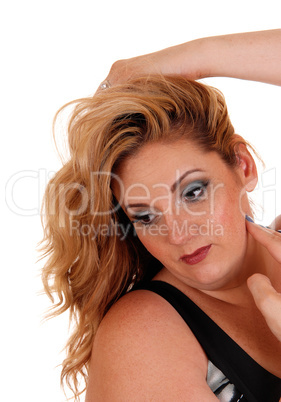 Smiling blond woman with hand on head.