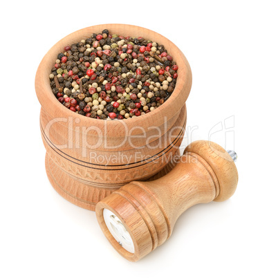assortment of spices in wooden pot and mill