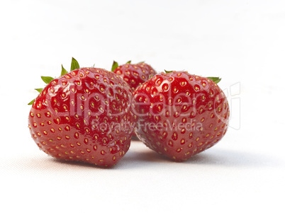 Three fresh ripe red strawberries
