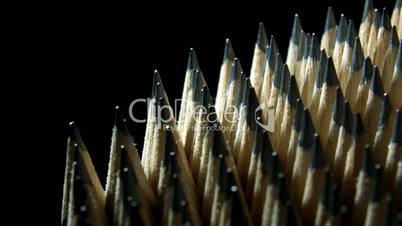 Close up of identical graphite pencils in rotation