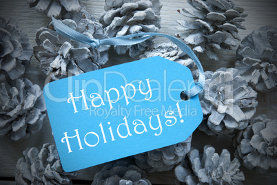 Light Blue Label On Fir Cones With Happy Holidays
