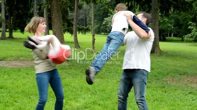 family (middle couple in love, cute girl and small boy) play together in park