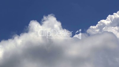 Great white clouds over the clean deep blue sky. Time lapse