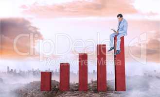 Composite image of businessman reading book while sitting over w
