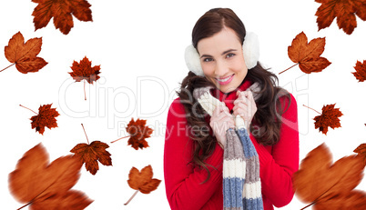 Composite image of happy brunette in winter clothes smiling at c