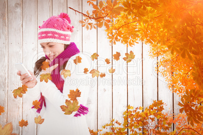 Composite image of attractive woman using her smartphone