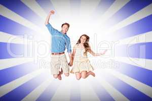 Composite image of cheerful young couple jumping