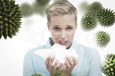 Composite image of blonde sick woman holding lots of tissues