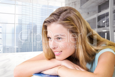 Composite image of thoughtful pretty female student in library