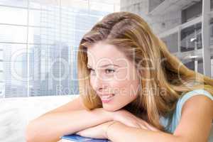 Composite image of thoughtful pretty female student in library