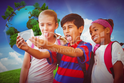 Composite image of school kids taking selfie in school corridor