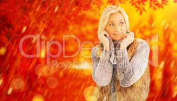 Composite image of blonde in winter clothes smiling