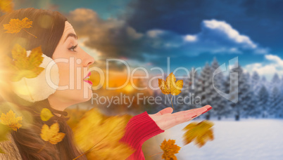 Composite image of brunette in winter clothes with hand out