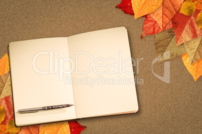 Composite image of notebook and pen