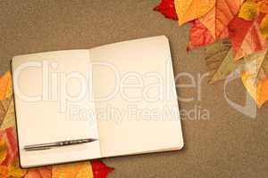 Composite image of notebook and pen