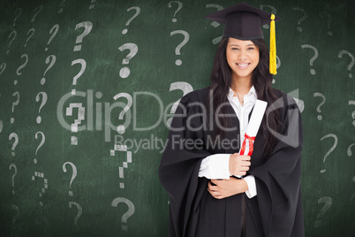 Composite image of woman with her degree dressed in her graduati