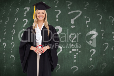 Composite image of smiling blonde student in graduate robe