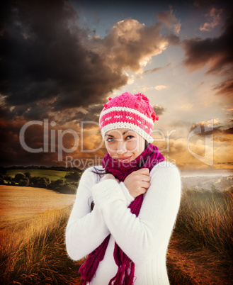 Composite image of attractive woman wearing warm clothes