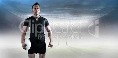 Composite image of tough rugby player holding ball