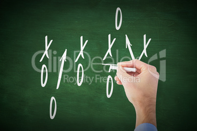 Composite image of hand writing with a white chalk