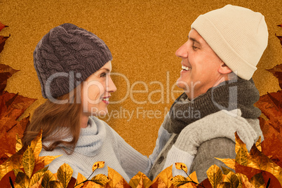 Composite image of happy couple in warm clothing