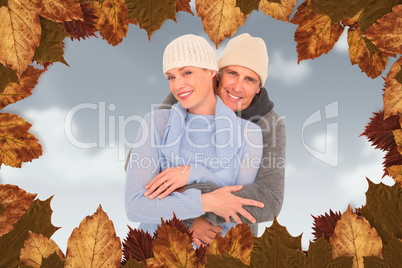 Composite image of casual couple in warm clothing