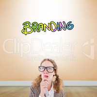 Composite image of geeky hipster woman thinking with hand on chi