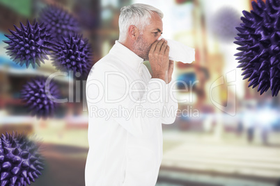 Composite image of sick man in winter fashion sneezing