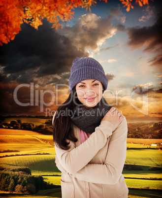 Composite image of attractive brunette looking at camera wearing