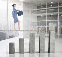 Composite image of businesswoman walking tightrope