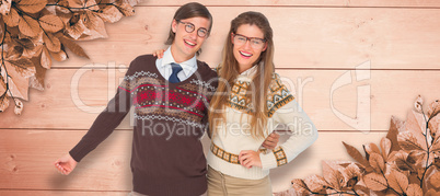 Composite image of happy geeky hipster couple embracing