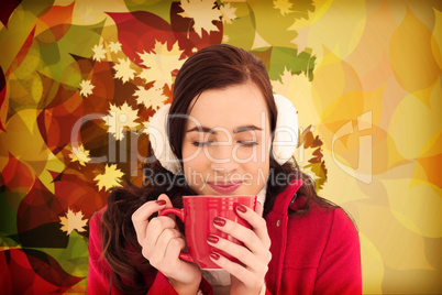 Composite image of woman in winter clothes enjoying a hot drink